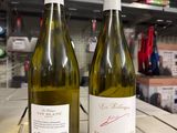 two bottles of wine sitting on a table in a store