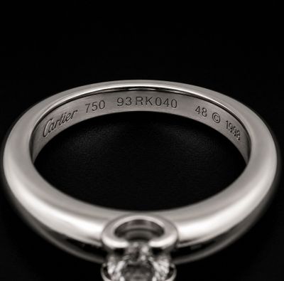 a close up of a ring with a diamond on it