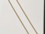 a gold necklace with an image of a woman on it
