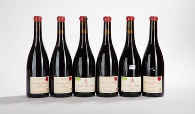 six bottles of wine lined up in a row on a white surface