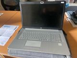 a laptop computer sitting on top of a wooden desk