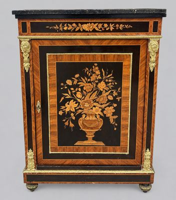 a small cabinet with a vase of flowers on it