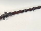 a rifle that is laying on top of a table