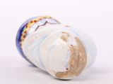 a close up of a vase on a white surface