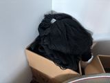 a pile of black yarn in a box next to a bicycle