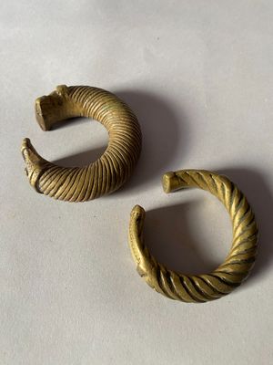 pair of gold toned hoop earrings on a white surface