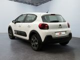 the rear end of a white citrole parked in a garage