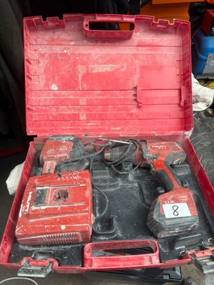 a red tool box with tools in it sitting on a table