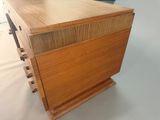 an image of a wooden chest of drawers on a white surface