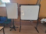 un tableau blanc posé sur un support dans une pièce