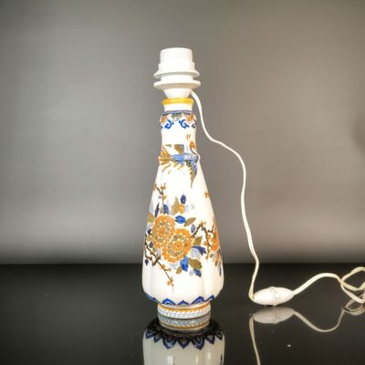 a white bottle with a blue and yellow design on it