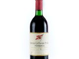 bottle of red wine with a red cap on a white background