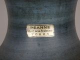 a close up of a blue vase with a tag on it
