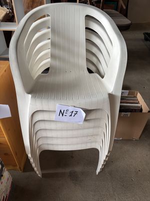 a stack of plastic chairs in a store with a price tag on the back