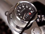 a close up of a motorcycle with a speedometer on it ' s handlebar