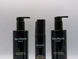 three bottles of balmain hair care on a white background