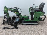 an image of a small excavator sitting on the ground