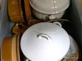 a blue box filled with dishes and bowls on the floor