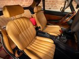 leather seats in a car with a brick wall in the background