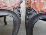 a pair of chairs that have been painted black and red