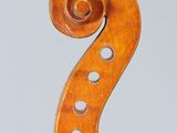 an old violin with a long neck and a long tail