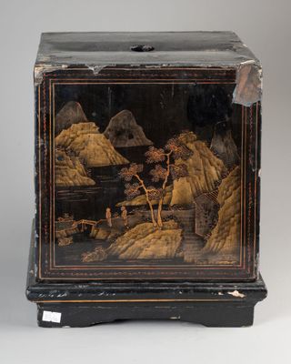 an image of a black and gold painted box on a stand