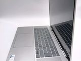 a silver laptop computer sitting on top of a white table