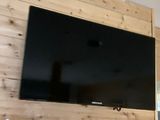 a flat screen tv mounted on the wall in the living room