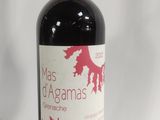 a bottle of wine that is sitting next to a glass of wine