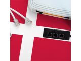 a cable plugged into a white box on a red and white table