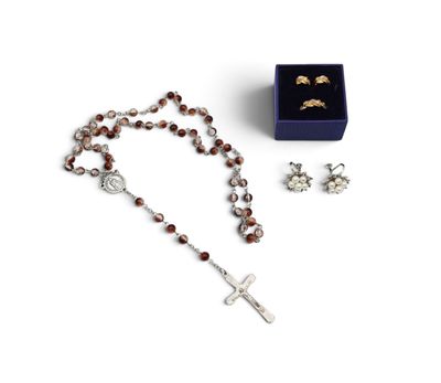 a rosary, ring, and earring set in a blue box