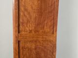 an image of a tall wooden cabinet with a drawer underneath it