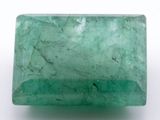 a close up of a green emerald stone on a white surface