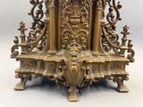 a gold clock that is sitting on top of a table