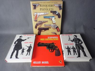 three books about revolvers and revolvers on a table