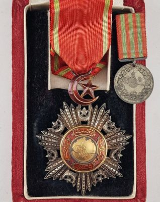 une image représentant une médaille et une médaille dans un étui rouge