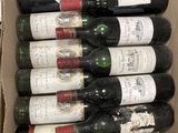 bottles of wine in a cardboard box sitting on a table