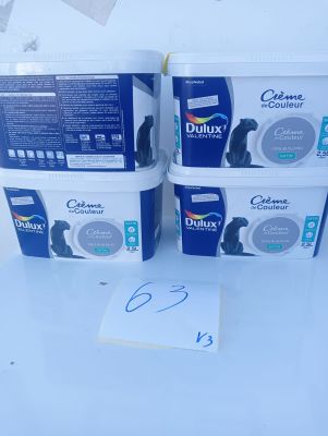 three containers of cat litter sitting on top of a white table