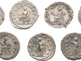 six ancient roman coins, one of which has been cleaned and one of which has been cleaned