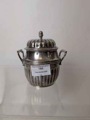 two silverplated dishes are on display on a glass shelf