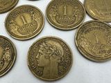 some coins are sitting on a white surface with a white background