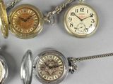 many different types of pocket watches on a table