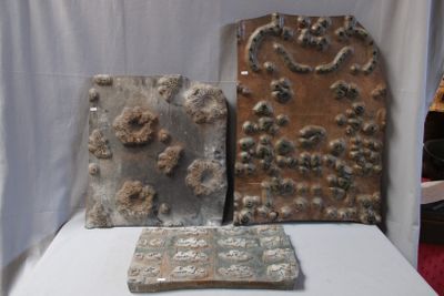 three pieces of art that are on a white table