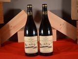two bottles of wine sitting on top of a table next to wooden crates