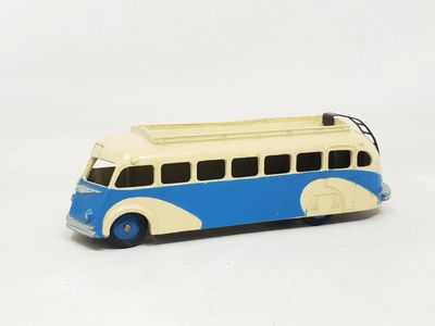 a toy bus that is sitting on a white surface