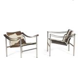 pair of lounge chairs with cow hide cushions