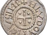 une pièce de monnaie en argent portant l'image d'une croix