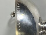 a silver lamp that is sitting on a table