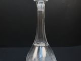 an image of a clear glass decanter sitting on a black surface