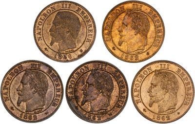 four different types of coins are shown on a white surface